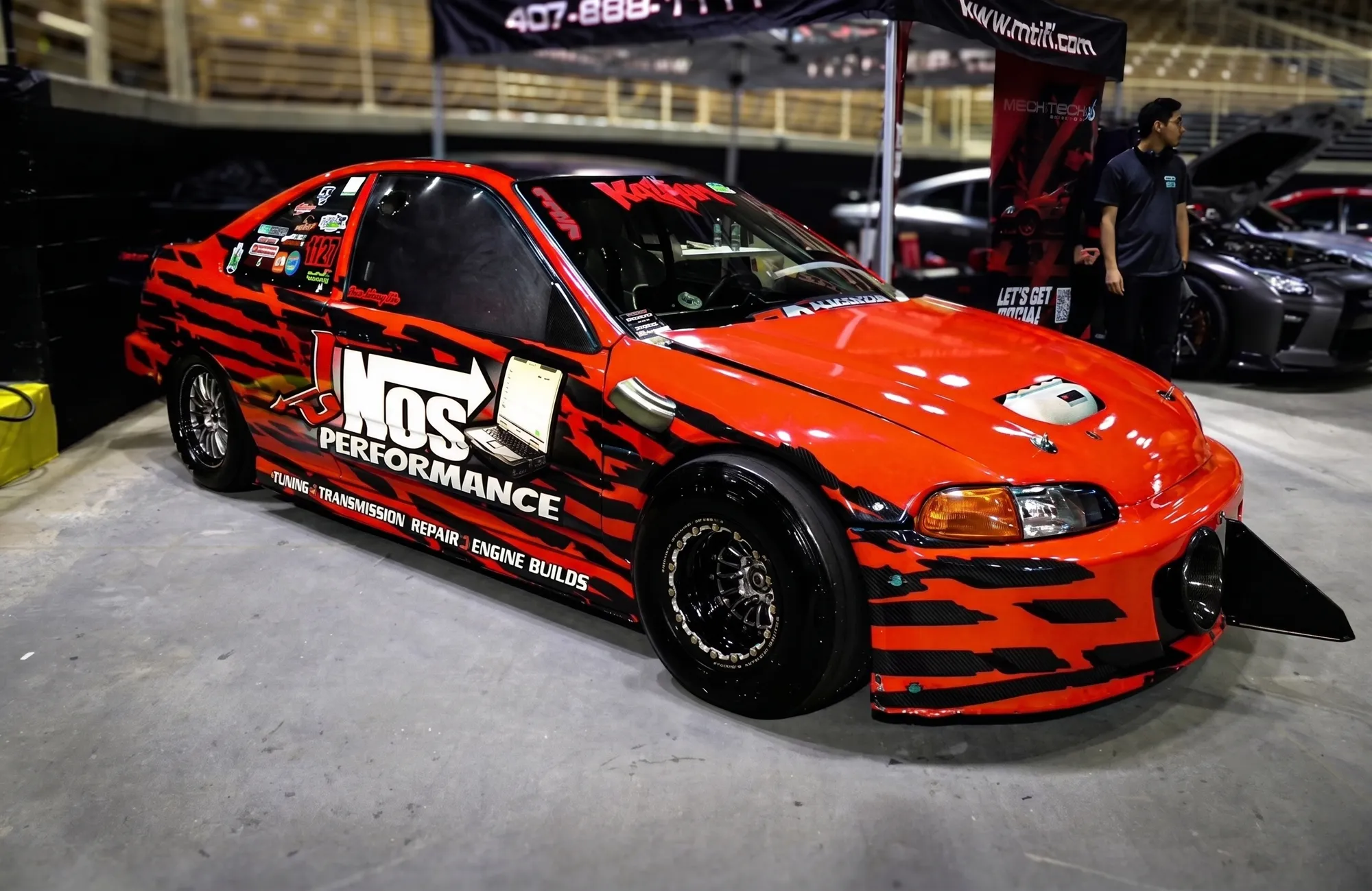 JNOS Performance liveried race car on the show floor